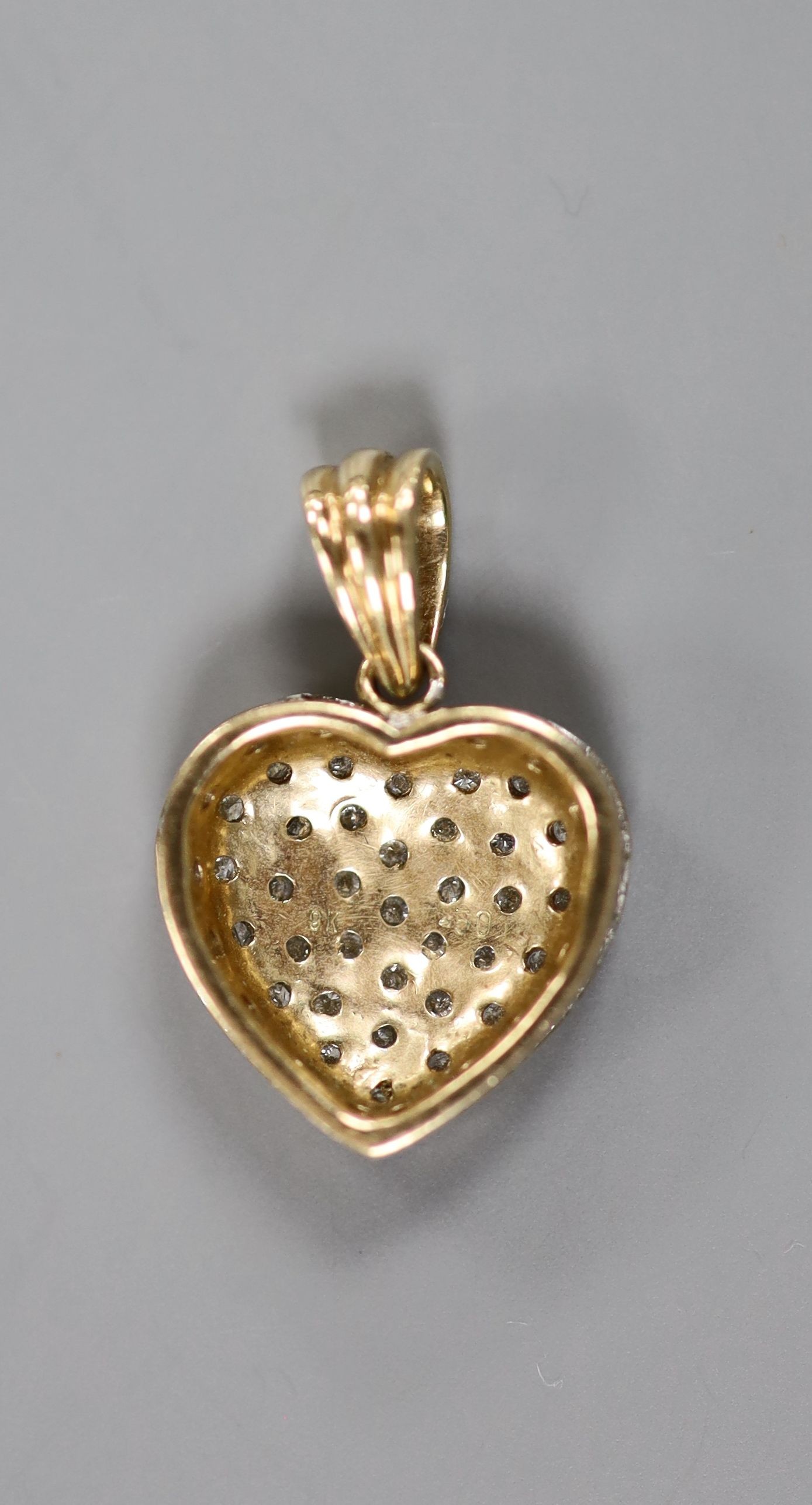 A modern 9k and pave set diamond chip heart pendant, overall 23mm, gross weight 3.3 grams.